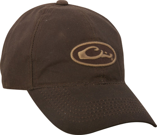A mid-profile, six-panel brown hat with a Purewhitelaneshop logo patch on the front. Made of 100% cotton canvas fabric. Features a self fabric closure with brass slide adjustment.