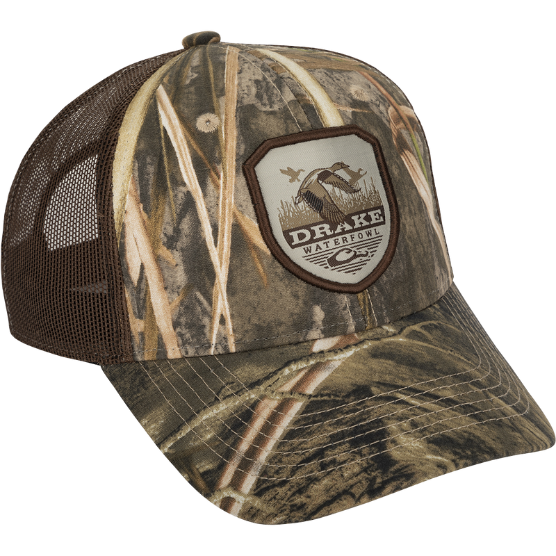 A vintage duck shield patch on a classic trucker mesh-back cap with the Drake logo, a go-to part of your outfit for any occasion.