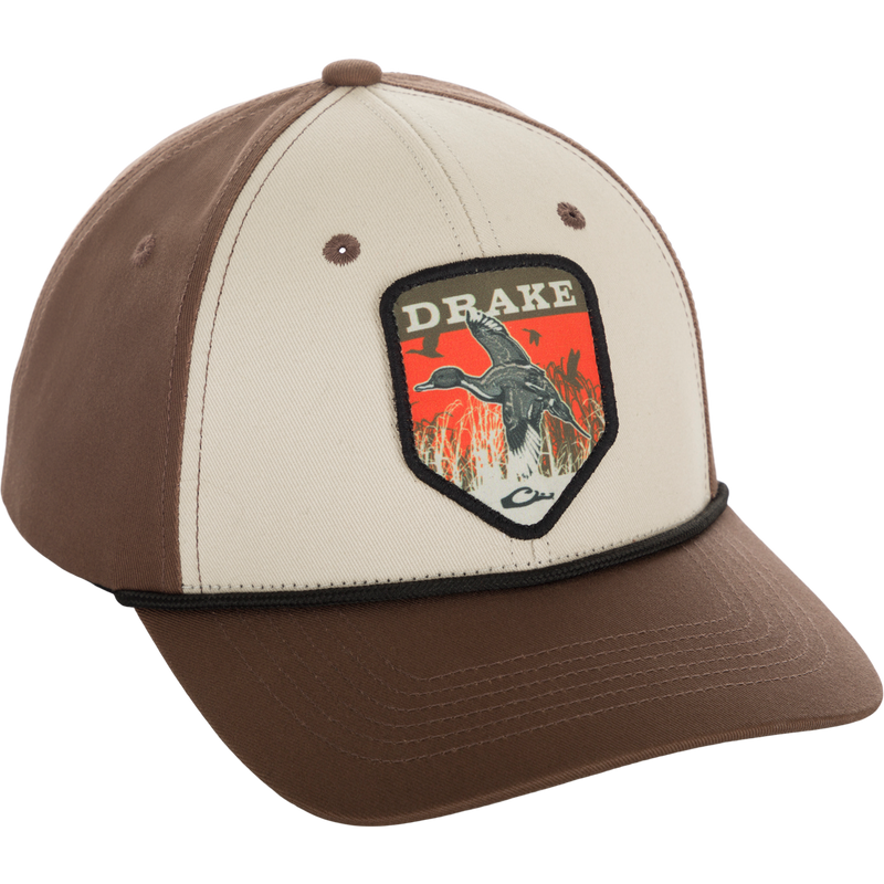 A Drake In-Flight Badge Cap with a duck patch and logo, made of 100% cotton. Adjustable snapback for a custom fit.