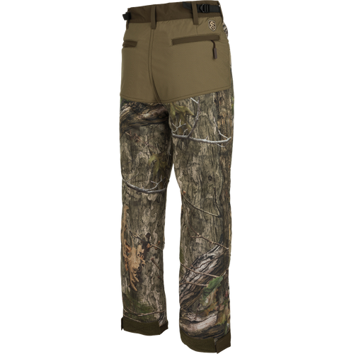 A pair of Standstill Windproof Pants with Agion Active XL®, perfect for late-season hunts. Made of durable fabric with scent control technology. Features adjustable waist and cuffs, front slash pockets, cargo pockets, and rear pockets. Essential for harsh cold and winds.