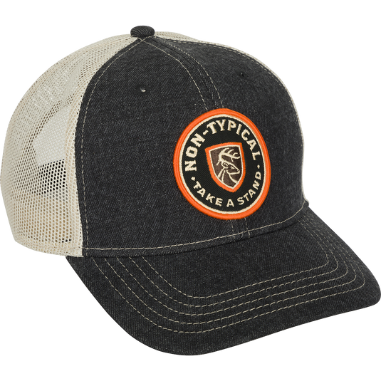 A black and white baseball cap with a logo patch on the front and a mesh back. Made with 100% cotton twill and adjustable snap closure.