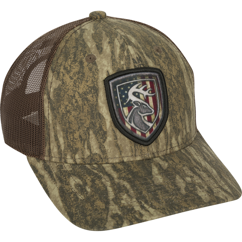 Americana Shield Patch Mesh-Back Cap with a deer flag patch on a hat. 100% cotton twill front panels with breathable mesh on the back. Rear snap closure.