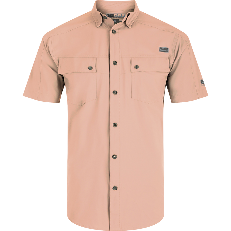 A close-up of the Performance Mesh Paneled Short Sleeve Shirt, featuring a hidden button-down collar, laser-punched mesh back panels for ventilation, and two button-through flap chest pockets. The shirt is made of a luxurious blend of nylon and spandex, offering stretch, drape, and high performance. It also provides UPF 50 sun protection, moisture-wicking, and quick-drying properties. Ideal for outdoor activities like hunting, fishing, and more.