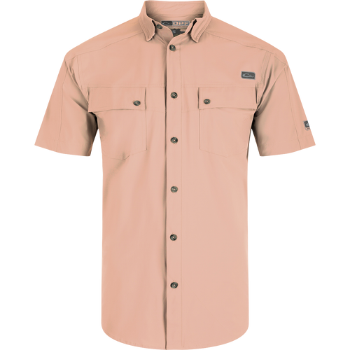 A close-up of the Performance Mesh Paneled Short Sleeve Shirt, featuring a hidden button-down collar, laser-punched mesh back panels for ventilation, and two button-through flap chest pockets. The shirt is made of a luxurious blend of nylon and spandex, offering stretch, drape, and high performance. It also provides UPF 50 sun protection, moisture-wicking, and quick-drying properties. Ideal for outdoor activities like hunting, fishing, and more.