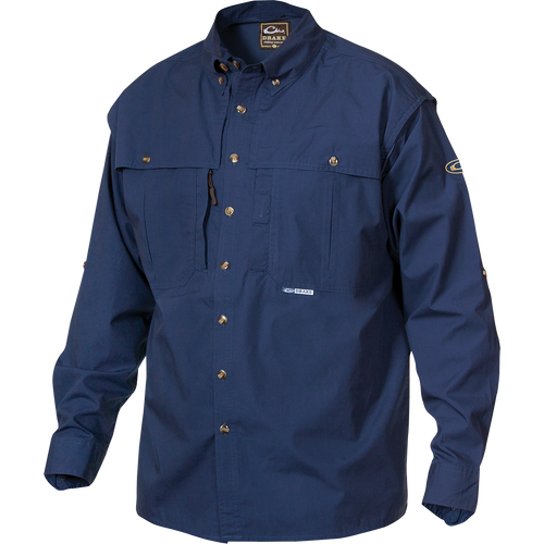 A blue long-sleeved shirt with a brown and white logo, front and back ventilation, oversized chest pockets, and a vertical zippered pocket. StayCool™ fabric keeps you cool and dry. Perfect for outdoor activities or casual office wear.