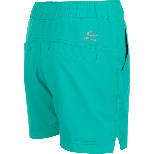 A pair of women's Commando Lined Shorts with a logo on the side, featuring clean lines, scalloped hem, and multiple pockets. 7