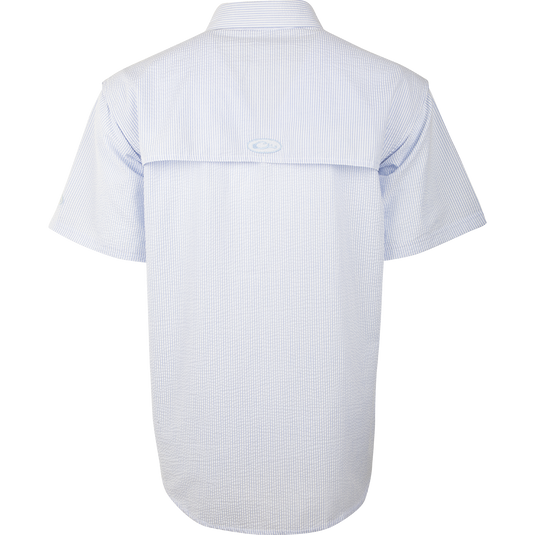 A Seersucker Wingshooter's Shirt with a button-down collar, heat vents, and multiple pockets. Made of StayCool™ fabric for breathability and wicking benefits. Perfect for spring and summer outings.
