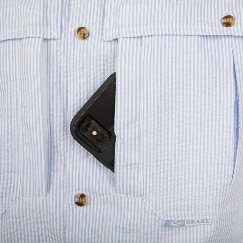 Seersucker Wingshooter's Shirt S/S - Blue: A cell phone in a shirt pocket, close-up of a phone, camera lens, and button.