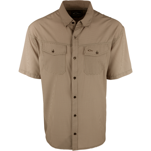 A brown checkered shirt with a four-way stretch fabric, moisture-wicking, and two chest pockets with button flaps. Traveler's Check Shirt S/S from Purewhitelaneshop.