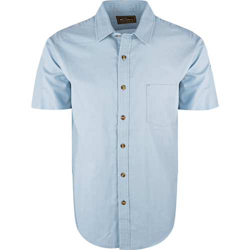 A light blue NeverTuck Shirt S/S with an open collar style and left chest pocket, made of soft-washed 100% cotton for comfort and breathability. Perfect for pairing with your favorite Drake outerwear.