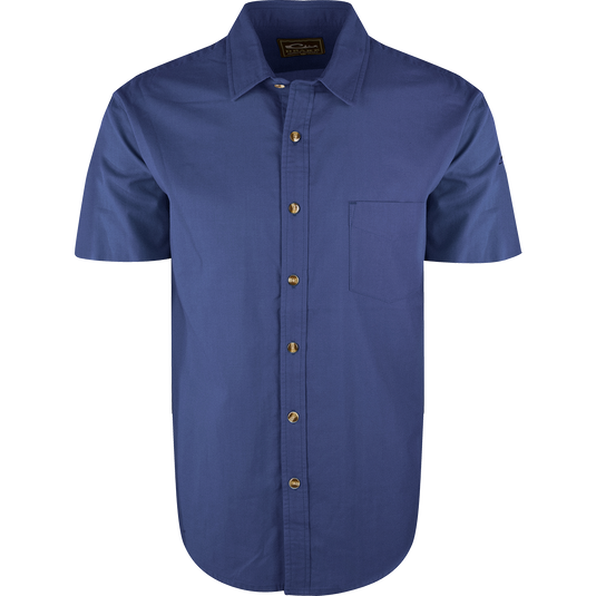 A blue NeverTuck Shirt S/S with buttons, made of soft-washed 100% cotton. Features include an open collar style and a left chest pocket. 