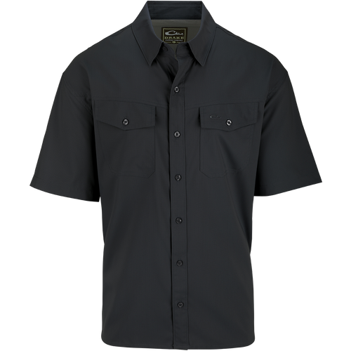 A black button-up shirt with hidden collar buttons, chest pockets, and a split tail hem. Made from 100% Polyester dobby fabric, it offers UPF30 sun protection and moisture-wicking properties. Versatile for any occasion. From Purewhitelaneshop, high-quality hunting gear and clothing.