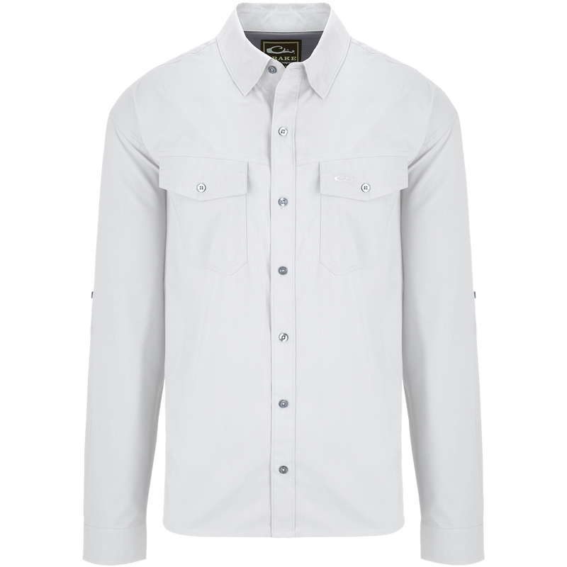 Traveler's Solid Dobby Shirt L/S: A white shirt with long sleeves, hidden button-down collar, and two chest pockets with button-through flaps. Classic fit, versatile for any season.