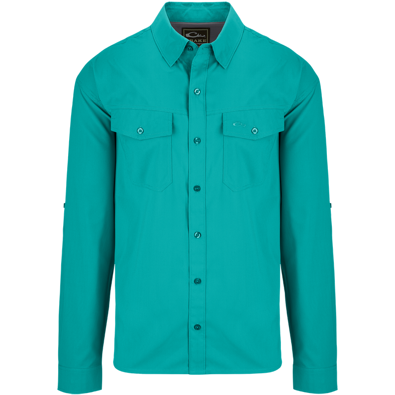 Traveler's Solid Dobby Shirt L/S: A classic fit long sleeve shirt with hidden button-down collar, chest pockets, and split tail hem. Made of featherweight polyester fabric with UPF30 sun protection. Versatile for any season.