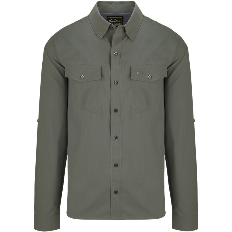 Traveler's Solid Dobby Shirt L/S: A classic fit, long-sleeved shirt with hidden button-down collar, chest pockets, and split tail hem. Made of featherweight, moisture-wicking fabric with UPF30 sun protection.