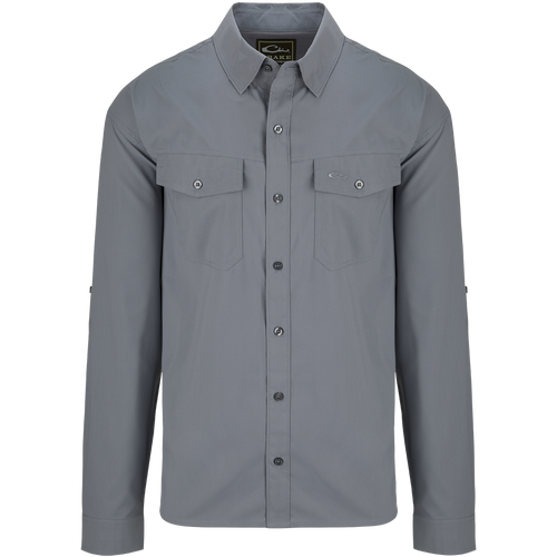 A versatile Traveler's Solid Dobby Shirt L/S with hidden button-down collar, chest pockets, and split tail hem. Featherweight, moisture-wicking fabric with UPF30 sun protection.