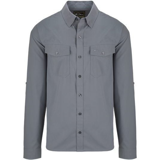 A versatile Traveler's Solid Dobby Shirt L/S with hidden button-down collar, chest pockets, and split tail hem. Featherweight, moisture-wicking fabric with UPF30 sun protection.