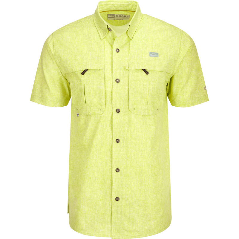 Heritage Heather Shirt S/S: A yellow shirt with pockets, button-down collar, and mesh ventilation. Lightweight, moisture-wicking, and UPF30 sun protection.