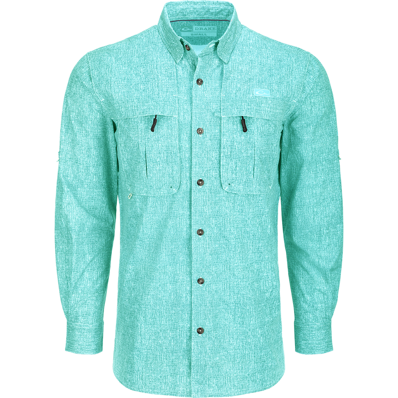 Heritage Heather Shirt L/S: A performance shirt with buttons, pockets, and adjustable roll-up sleeves. Made of lightweight, moisture-wicking polyester micro mesh for natural cooling and quick drying. Features UPF30 sun protection, hidden button-down collar, vented cape back, and split tail hem. Ideal for outdoor activities or office wear.