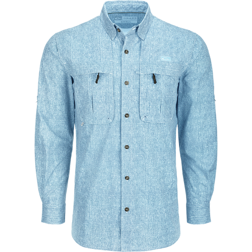 A close-up of the Heritage Heather Shirt L/S, a long-sleeved blue shirt with hidden button-down collar, vented cape back, and two front chest pockets. Lightweight, moisture-wicking, and quick-drying fabric with UPF30 sun protection. Perfect for performance on the water or at the office.