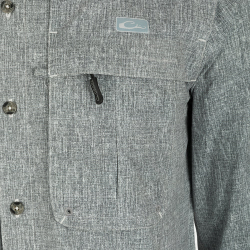 A close-up of the Heritage Heather Shirt L/S, showcasing its button-down collar, chest pockets, and split tail hem.