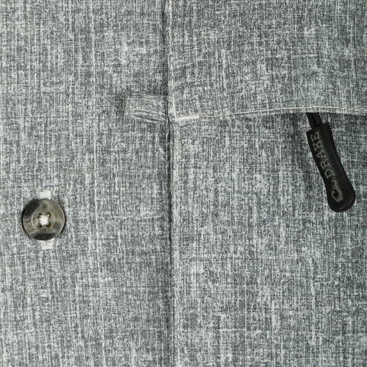 Heritage Heather Shirt L/S: A close-up of a button on a grey patterned shirt made of lightweight, moisture-wicking polyester fabric with UPF30 sun protection.