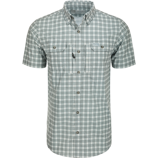 Hunter Creek Check Plaid Shirt S/S: A close-up of a grey and white plaid shirt with a hidden button-down collar and two button-through chest pockets.