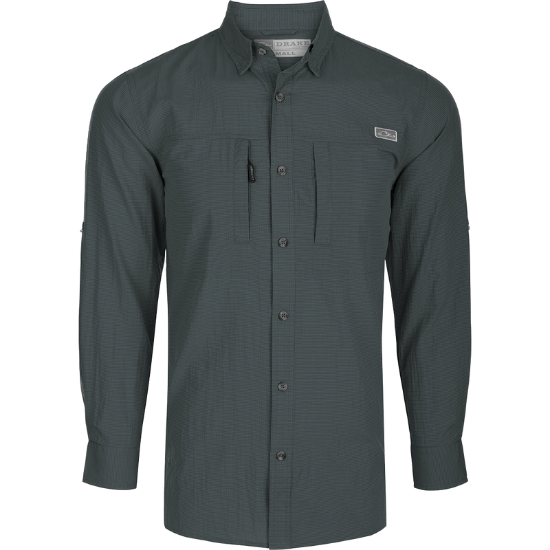 Classic Seersucker Minicheck Shirt L/S: A black long-sleeved shirt with buttons, featuring a hidden zippered chest pocket and a magnet closure on the other pocket. Made from a soft and featherweight performance fabric with UPF30 sun protection. Vented cape back and split tail hem for added ventilation and versatility. Perfect for hunting, fishing, and outdoor activities.