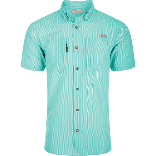 Classic Seersucker Stripe Shirt S/S: A close-up of a soft, featherweight shirt with a seersucker texture. Features include UPF 30 sun protection, moisture-wicking, and a button-down collar. It has a hidden zippered right chest pocket and a left chest pocket with a Magnattach™ closure. The vented cape back provides additional ventilation, and the split tail hem allows for versatile styling. The image shows the shirt's pattern and fabric.