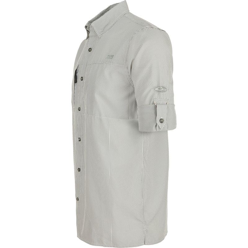 A close-up of the Classic Seersucker Stripe Shirt L/S, featuring a textured pattern and button-down collar. Made from 72% Polyester and 28% Nylon, it offers UPF30 sun protection, moisture-wicking, and quick-drying properties. With a vented cape back and hidden zippered chest pockets, this shirt combines performance and timeless style. Perfect for hunting, fishing, and casual wear.