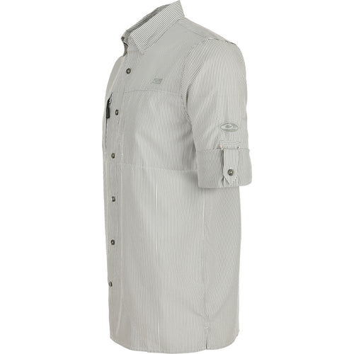 A close-up of the Classic Seersucker Stripe Shirt L/S, featuring a textured pattern and button-down collar. Made from 72% Polyester and 28% Nylon, it offers UPF30 sun protection, moisture-wicking, and quick-drying properties. With a vented cape back and hidden zippered chest pockets, this shirt combines performance and timeless style. Perfect for hunting, fishing, and casual wear.