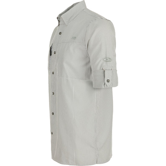 A close-up of the Classic Seersucker Stripe Shirt L/S, featuring a textured pattern and button-down collar. Made from 72% Polyester and 28% Nylon, it offers UPF30 sun protection, moisture-wicking, and quick-drying properties. With a vented cape back and hidden zippered chest pockets, this shirt combines performance and timeless style. Perfect for hunting, fishing, and casual wear.