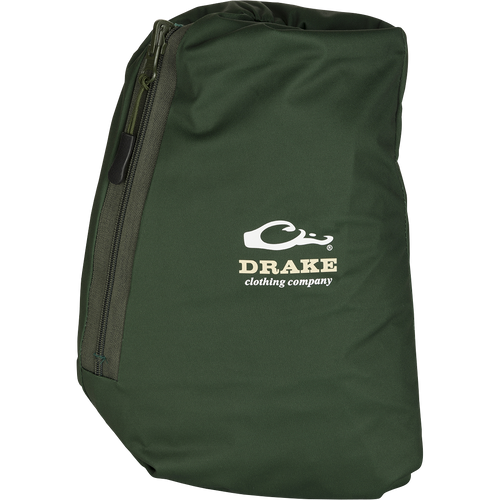 A close-up of the Tempest Ultralight Packable Rain Pant's green bag with a zipper, featuring a logo.