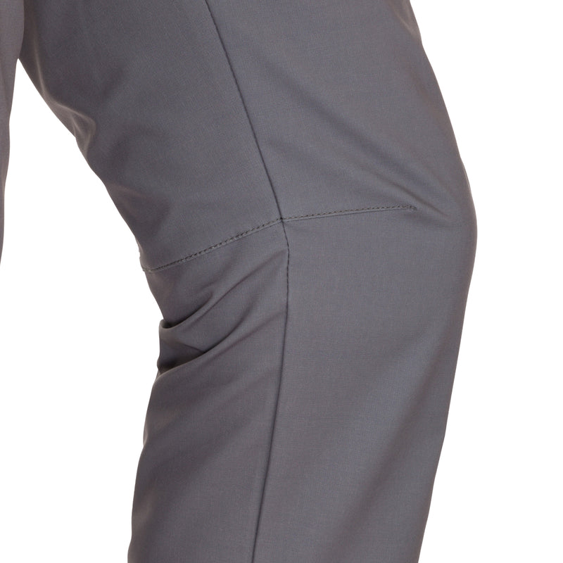 A close-up of the Traveler Trek Pant, a rugged and sophisticated garment from Purewhitelaneshop. Made of 90% Polyester and 10% Spandex, it offers built-in stretch, moisture-wicking, and quick-drying properties. The pant features articulated knees, multiple pockets, and a YKK zippered cargo pocket. Perfect for your next adventure.