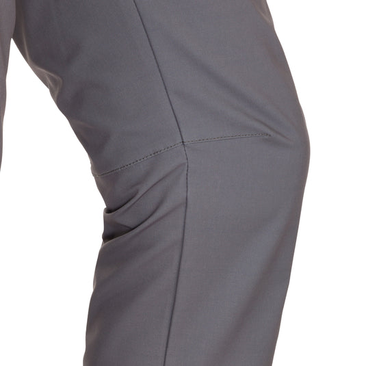 A close-up of the Traveler Trek Pant, a rugged and sophisticated garment from Purewhitelaneshop. Made of 90% Polyester and 10% Spandex, it offers built-in stretch, moisture-wicking, and quick-drying properties. The pant features articulated knees, multiple pockets, and a YKK zippered cargo pocket. Perfect for your next adventure.