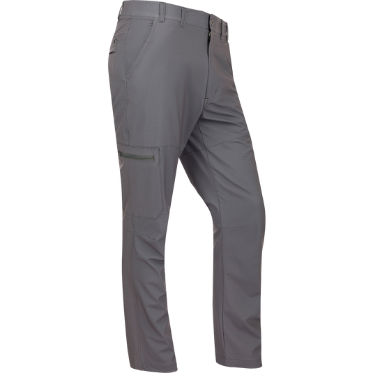 A pair of lightweight, straight leg Traveler Trek Pants with built-in stretch and moisture-wicking fabric. Features include elastic side waist, front slash pockets, and hidden zippered back pockets. Perfect for your next adventure.