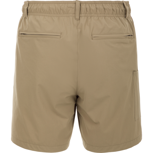 Dock Short 6" - backside of tan swim trunk shorts  with a zipper and stitched leather detail. Made from durable, quick-drying 90% Nylon/10% Spandex fabric. Features elastic waist, belt loops, and multiple mesh-lined pockets. Perfect for boat to dock transitions.