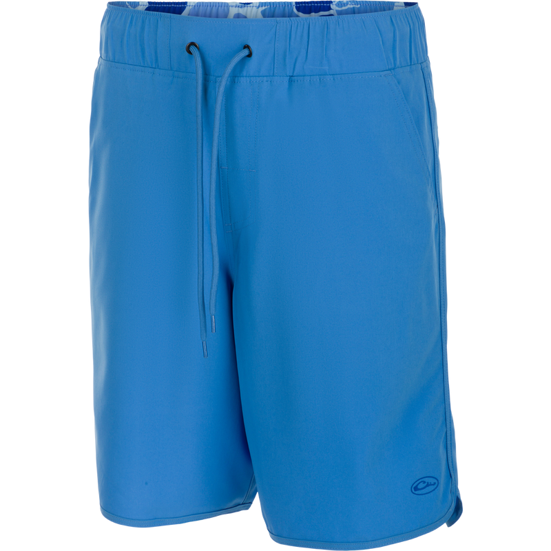 A versatile Commando Lined Volley Short 9 inch with built-in liner. Features quick-drying fabric, 4-way stretch, and adjustable waistband. Includes front and back pockets with hidden zippers. Perfect for beach to bar.