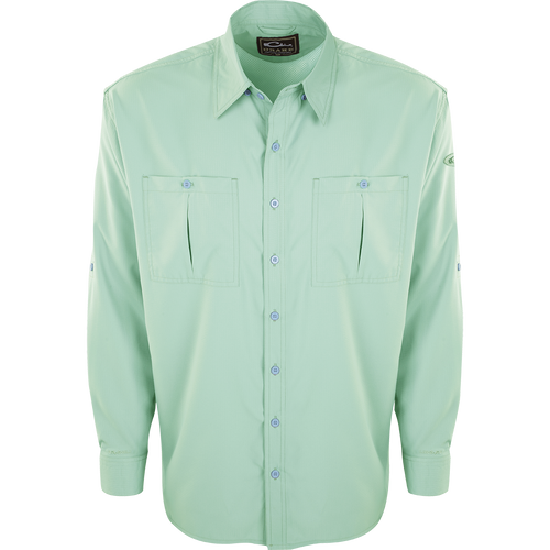 A close-up of the Flyweight Shirt with Vented Back L/S, featuring a green button-up design, collar, and sleeve. Made of ultra-lightweight polyester, it offers quick-drying, moisture-wicking, and breathable properties. With Sol-Shield™ UPF 50+ sun protection, vented mesh back, and horizontal chest pockets, it's perfect for warm-weather outdoor activities.