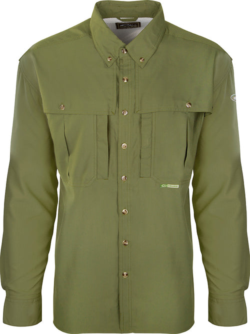 A close-up of the Youth Flyweight Wingshooter's Shirt, a green shirt with buttons. Lightweight, quick-drying, and easy to clean, this comfortable and stylish shirt is perfect for active kids at school, play, and in the outdoors. Made with 100% Polyester twill fabric and featuring a Magnattach™ left chest pocket, front and back heat vents, a sun blocker extension collar, and more. Ideal for waterfowl family adventures.