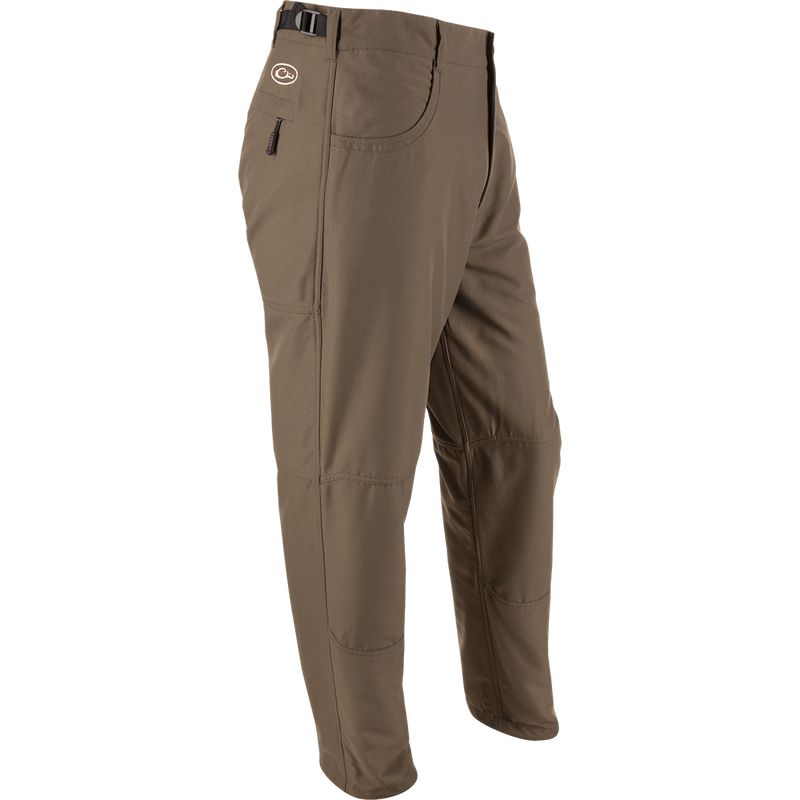 MST Jean Cut Wader Pant: Brown trousers with pockets, adjustable waist, and ankle cord locks. Ideal for outdoor activities and wearing under waders.