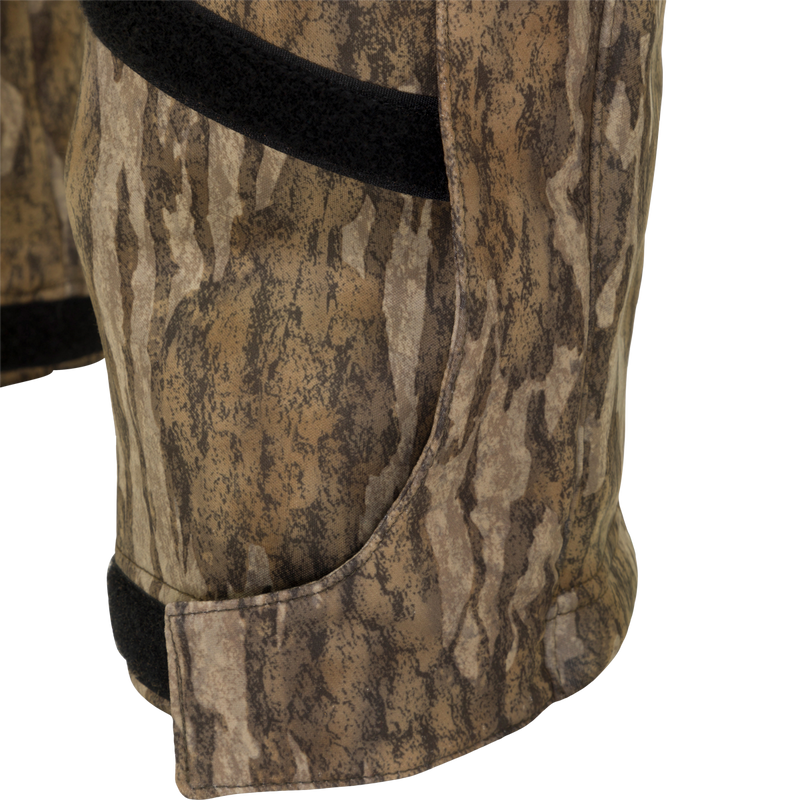 MST Ultimate Wader Bib: Close-up of camouflage shorts with black band, Sherpa-lined pockets, and zippered rear security pockets.