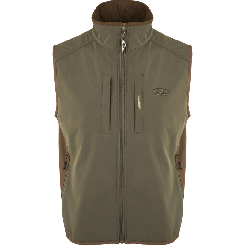 EST Windproof Tech Vest, featuring a logo and zipper details. This khaki vest is made of high-quality polyester tech shell and bonded fleece lining with a windproof membrane. It's perfect for outdoor activities and can be worn as a core or outer layer. Stay warm and stylish with this versatile vest from Purewhitelaneshop.
