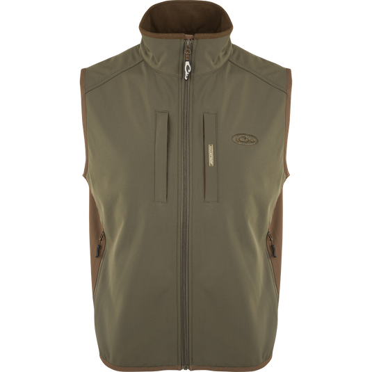 EST Windproof Tech Vest, featuring a logo and zipper details. This khaki vest is made of high-quality polyester tech shell and bonded fleece lining with a windproof membrane. It's perfect for outdoor activities and can be worn as a core or outer layer. Stay warm and stylish with this versatile vest from Purewhitelaneshop.
