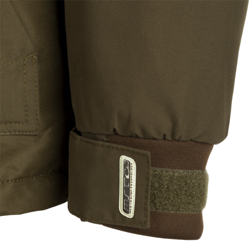 MST Waterproof Fleece-Lined 1/4 Zip Jacket: A close-up of a khaki jacket with adjustable cuffs, multiple pockets, and a rear storage pouch.
