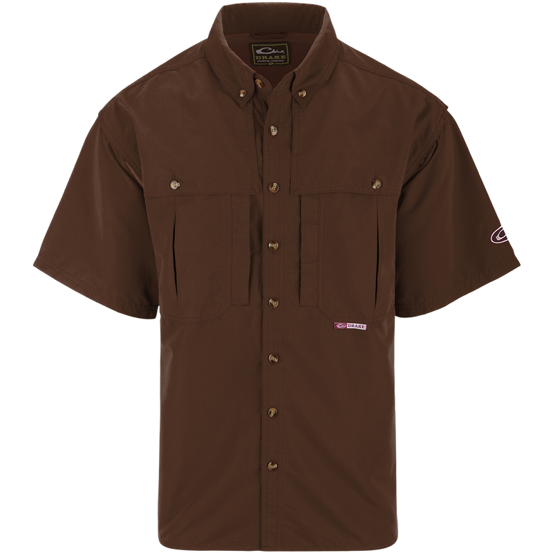 A brown short sleeved shirt with a logo on the chest, perfect for outdoor activities. Features include front and back ventilation, oversized chest pockets, and a zippered pocket. Made with wrinkle-resistant EasyCare™ fabric and a poly-mesh lining for breathability. From Purewhitelaneshop, known for high-quality hunting gear and clothing.