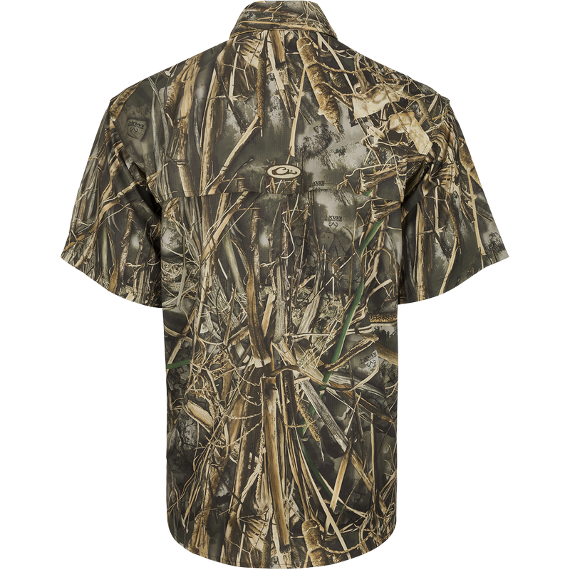 Back view of the EST Camo Flyweight Wingshooter's Shirt S/S, a lightweight and breathable hunting shirt. Made of 100% polyester Flyweight fabric with Sol-Shield™ UPF 50+ sun protection. Features include back heat vents, mesh side panels, Magnattach™ vertical chest pocket, and quick-drying properties. Perfect for early season hunts.