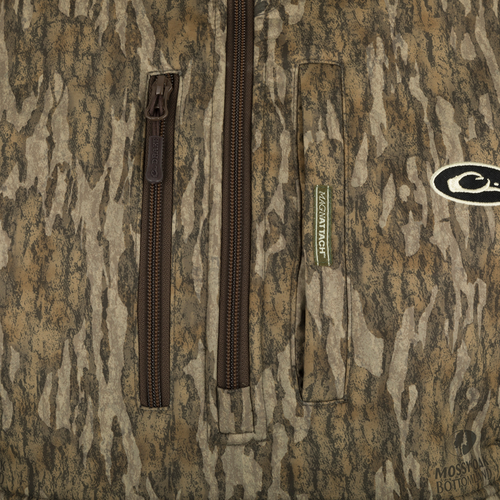 MST Hole Shot Windproof Eqwader 1/4 Zip Jacket: Close-up of logo and zipper on beige patterned fabric. Superior protection and temperature control for any weather. Sherpa-lined upper body, breathable lower body, and adjustable features for comfort.