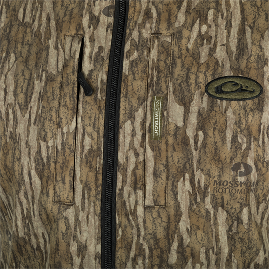 A close-up of the MST Windproof Softshell Vest, showcasing its expert-level functionality. Features include multiple pockets for secure storage, adjustable drawcord waist, and a comfortable grid-fleece collar lining. Made with high-quality materials for superior comfort and breathability.