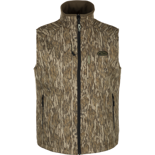 MST Windproof Softshell Vest with camouflage pattern, Magnattach™ chest pocket, and zippered pockets for secure storage. Customizable fit with drawcord waist. Superior comfort and breathability with 4-way stretch and grid-fleece collar lining. Expert-level functionality for hunting and outdoor activities.